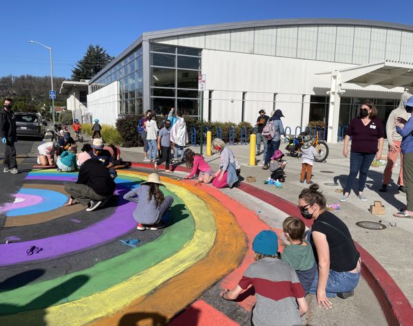 Families painting a rainbow crosswalk in Albany